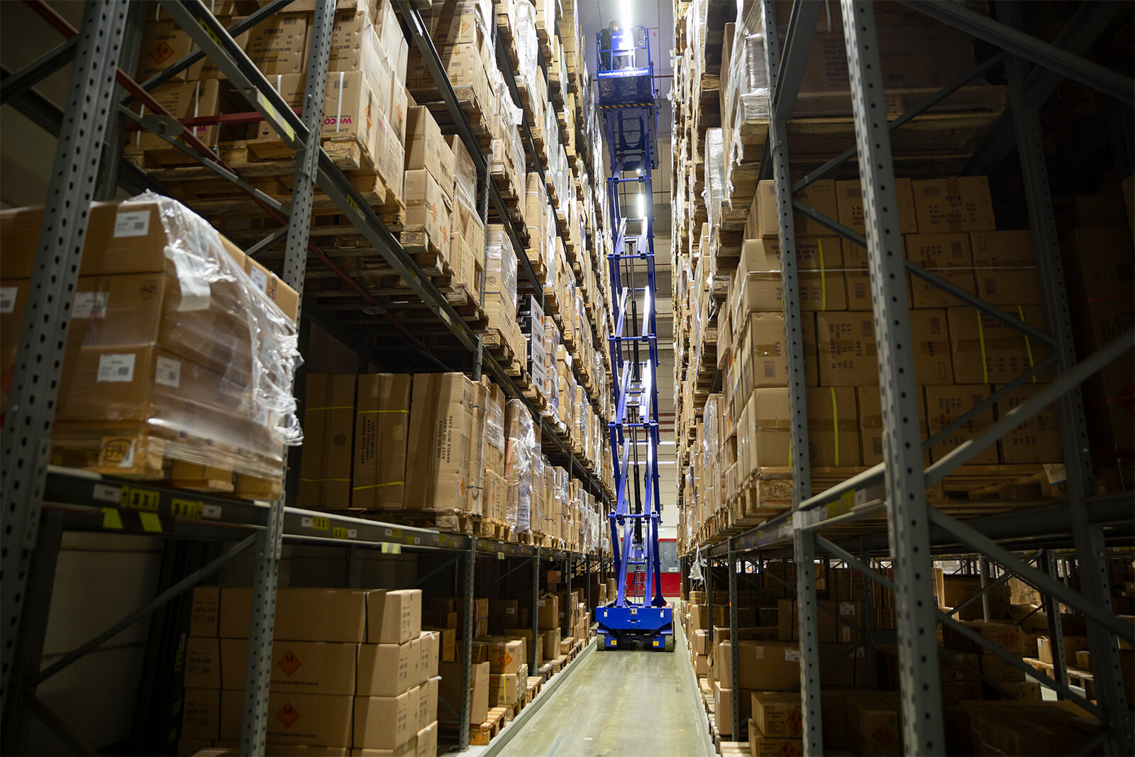 Scherenbühne SB 158 ELDI bei Einsatz in Hochregallager von Weco